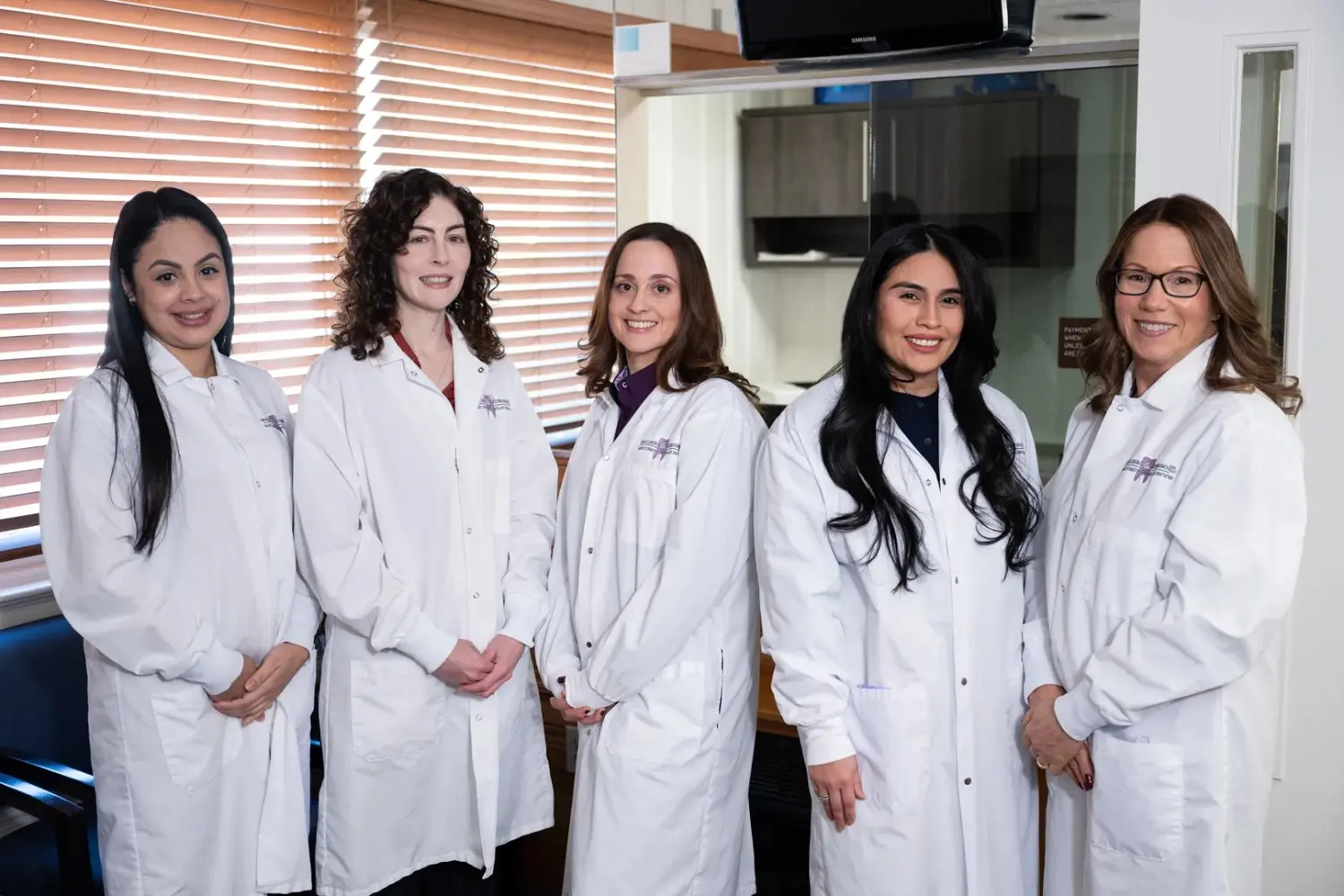Home 10 Five female dentists posing in lab coats – Family Dentistry in Westbury, NY – Smallberg & Satornino, DDS, PLLC
